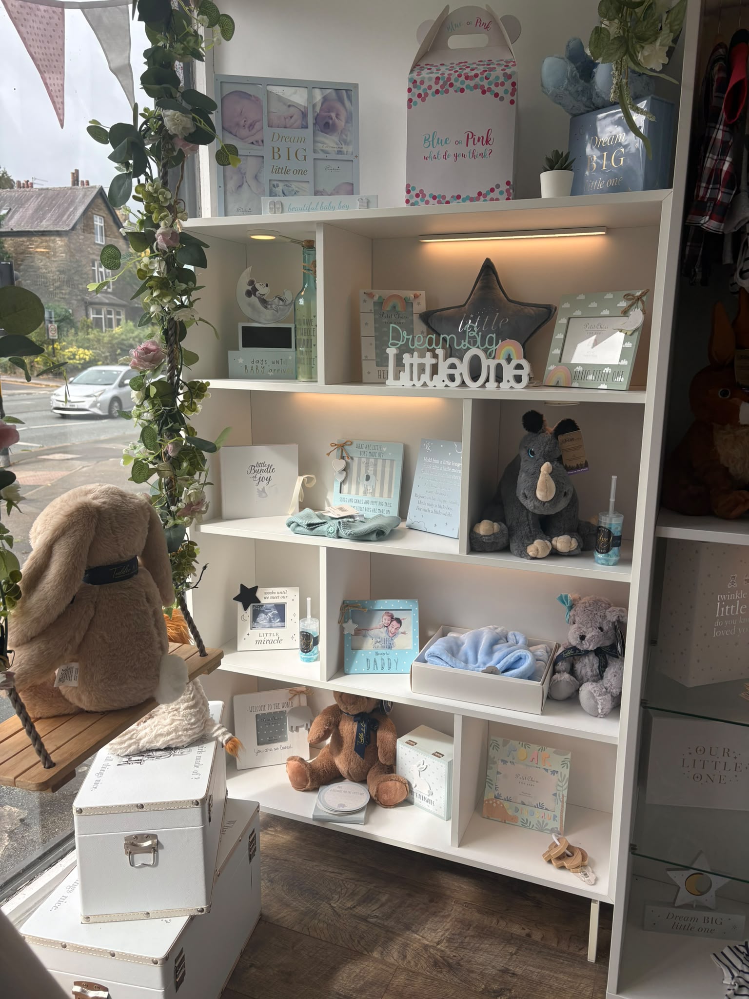 Shelves of baby gifts, photo frames and soft toys in the Precious Glimpse window