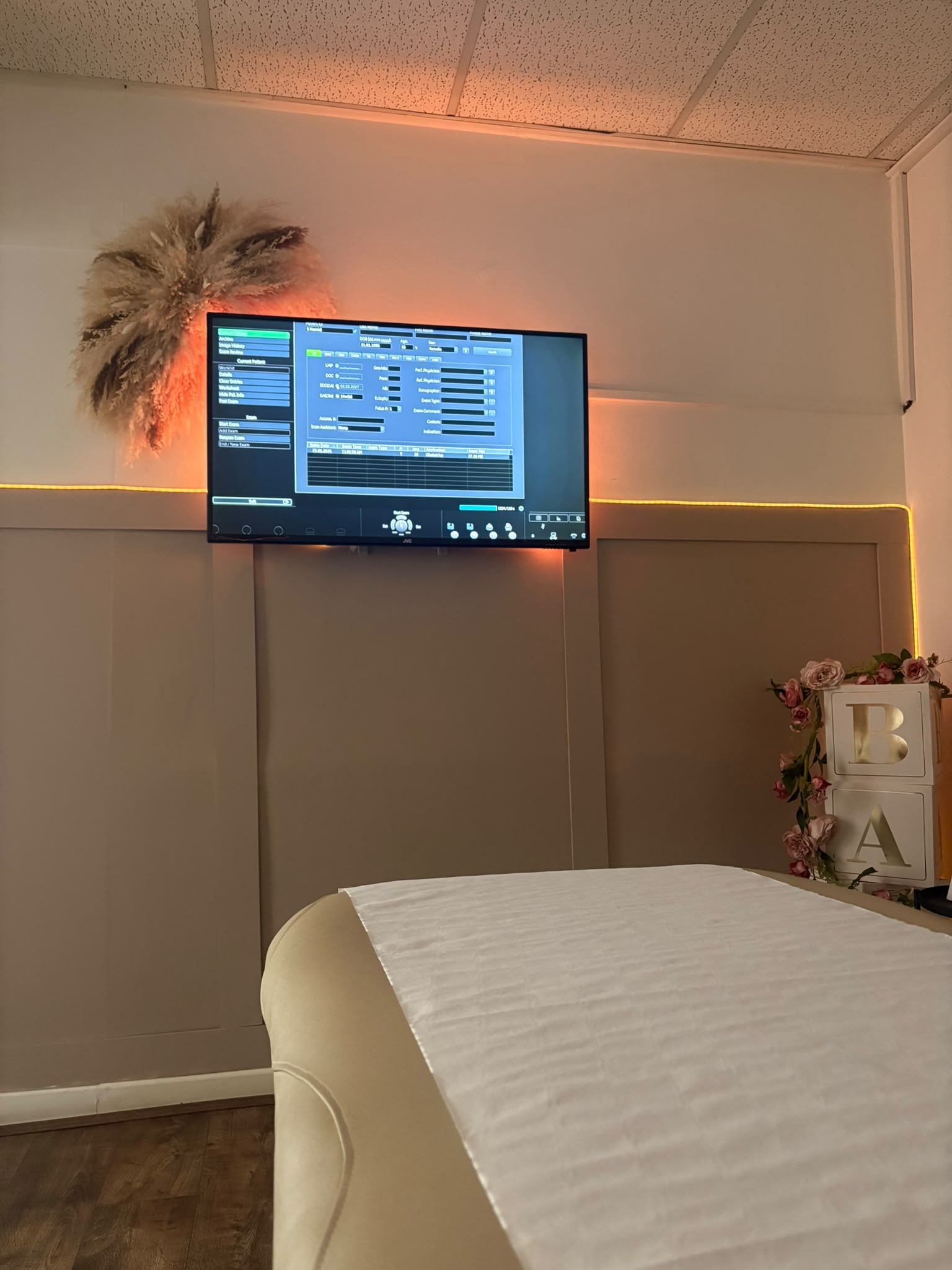 A scan room at Precious Glimpse, with the viewing screen mounted on the wall above the scan couch